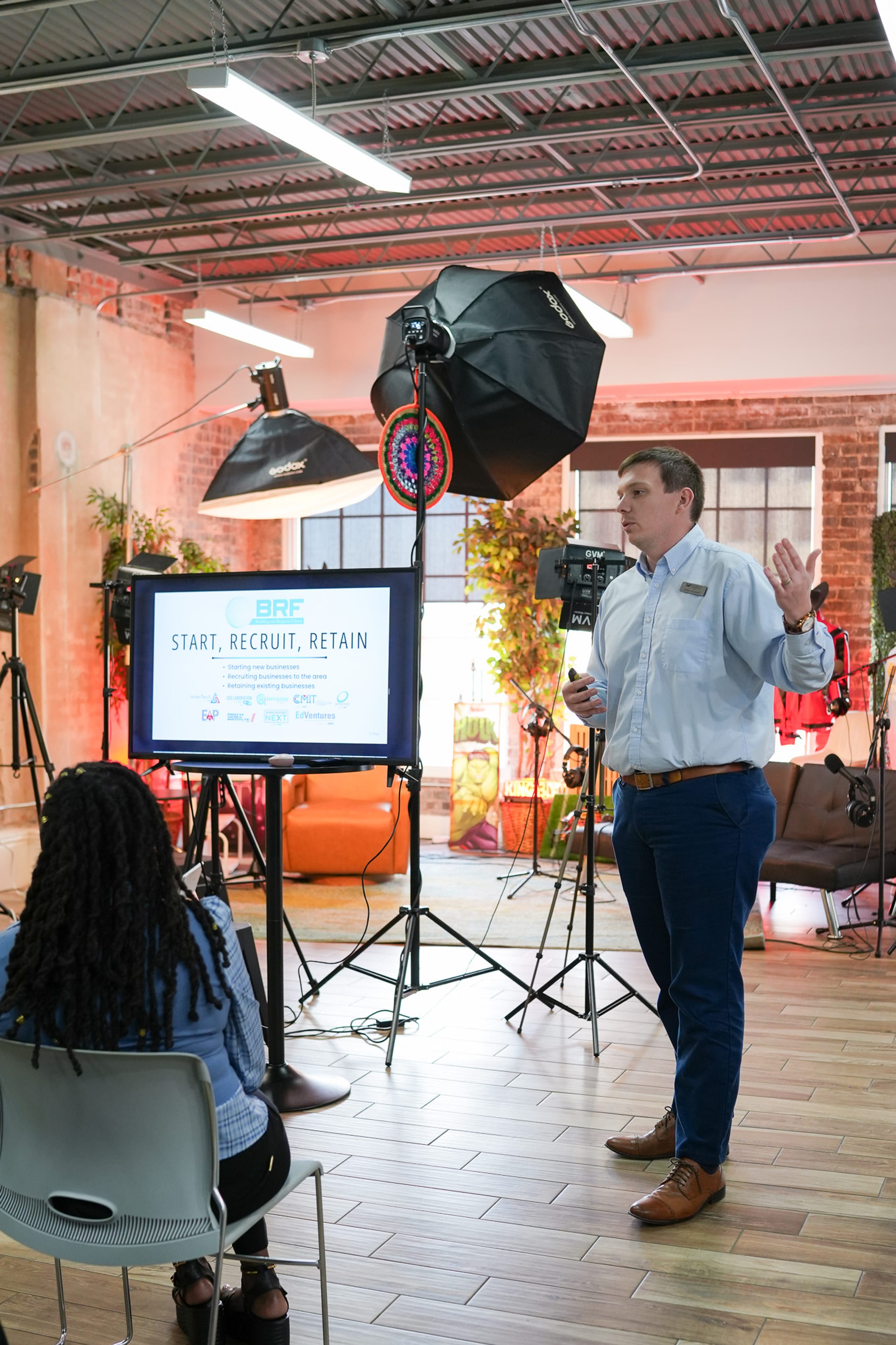 A man giving a presentation in a studio setting.