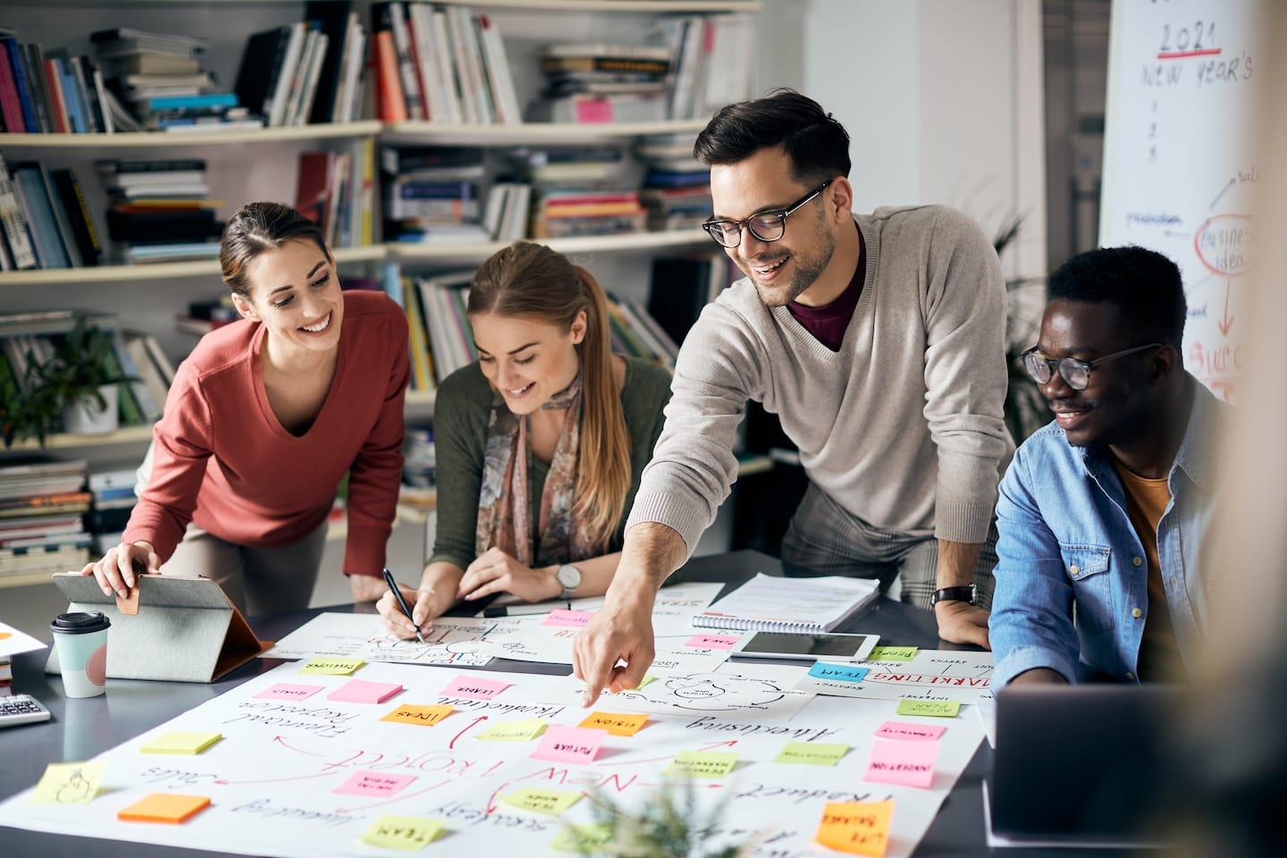 A group of four young professionals engaged in a brainstorming session