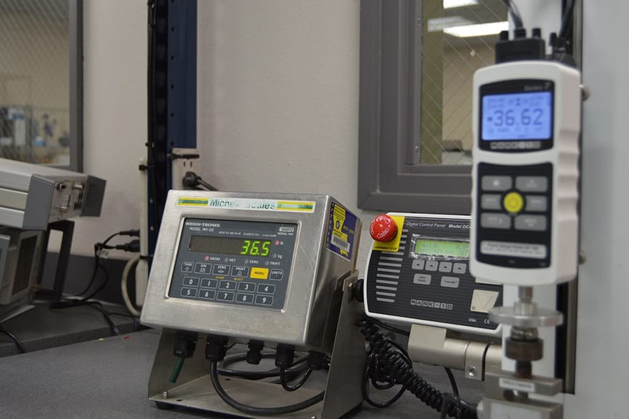 Industrial weighing scale in operation at manufacturing facility, precision measurement equipment