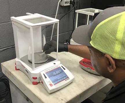 Michelli technician inspecting an analytical laboratory balance for accuracy verification
