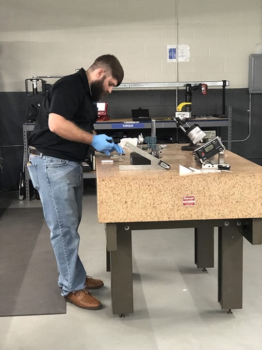 Precision measurement equipment calibration in progress on granite surface plate