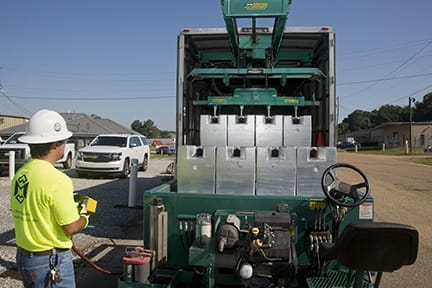 Michelli technician performing a scheduled preventative maintenance inspection on an industrial scale