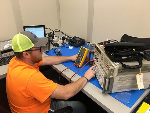 Michelli electronic calibration laboratory with test instruments and calibration standards on a workbench
