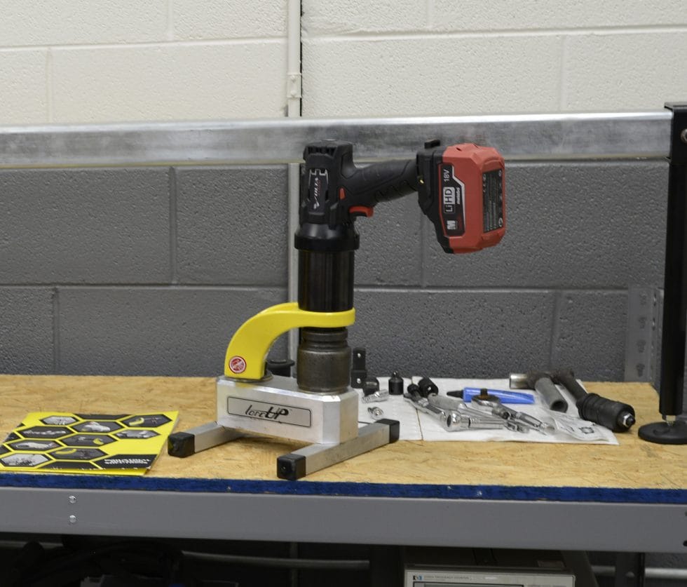 Mechanical click torque wrench positioned on a calibration bench ready for traceable torque calibration
