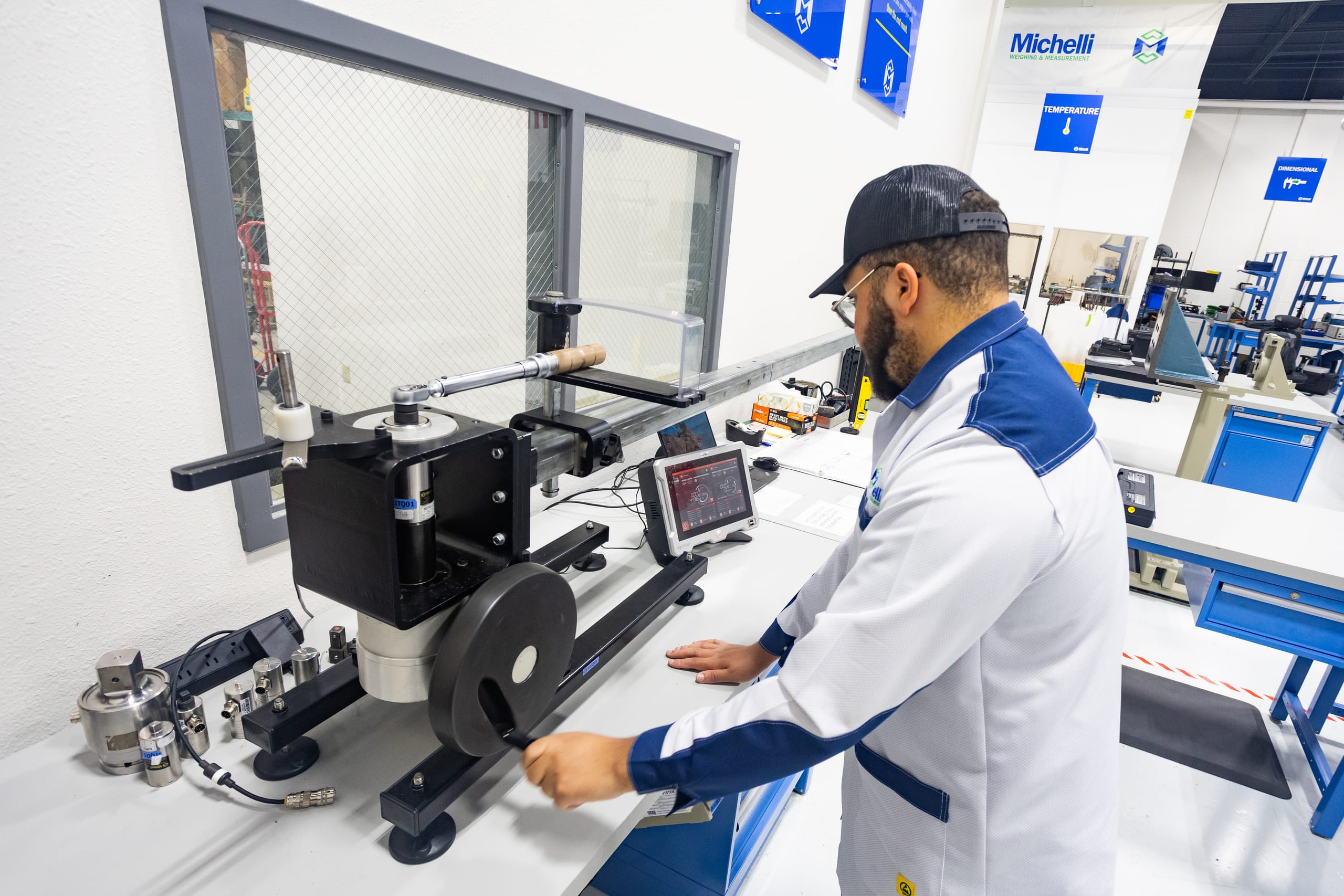 Michelli technician performing torque wrench calibration in a workshop