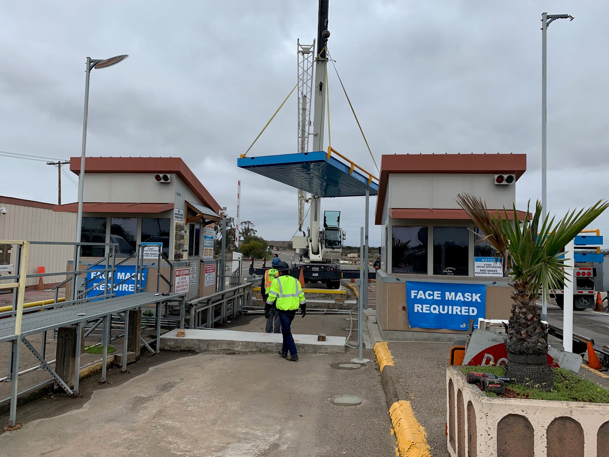 Toll booth construction site with crane and workers