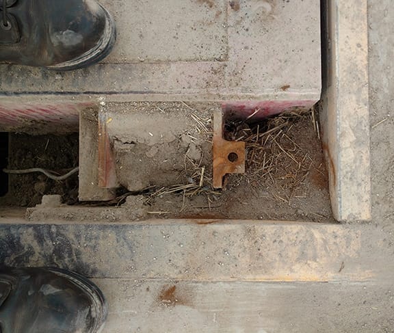 Dirt and debris build-up inside a truck scale pit