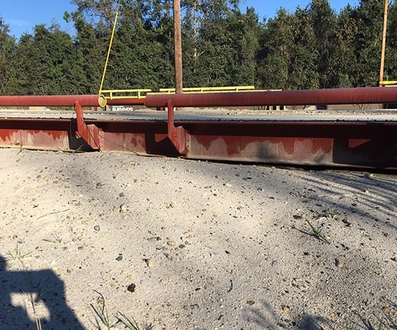 Debris on a truck scale deck causing it to weigh light