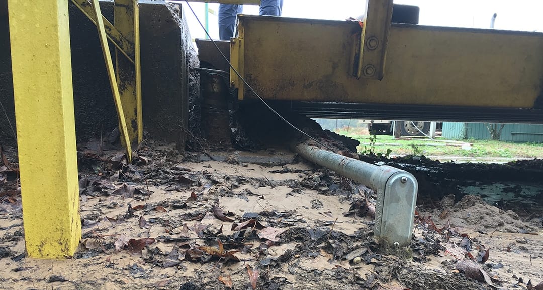 Debris build-up underneath a truck scale causing it to weigh light