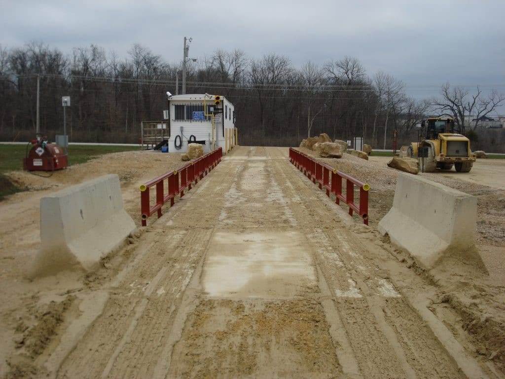 Water and debris buildup on top of a truck scale affecting accuracy