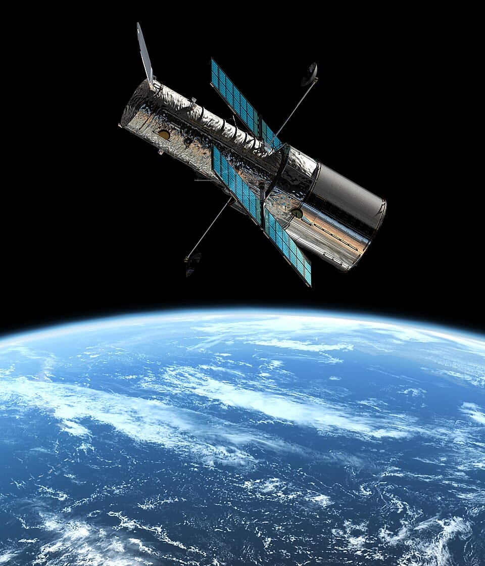 The Hubble Space Telescope in orbit around the Earth — a legacy connected to Susan Jane Cunningham's precision training