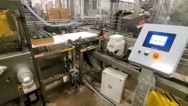 Automated production line with control panel and conveyor belt
