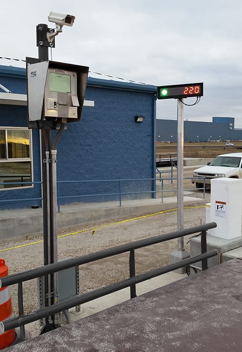 Industrial security camera and digital display mounted outside a truck scale facility
