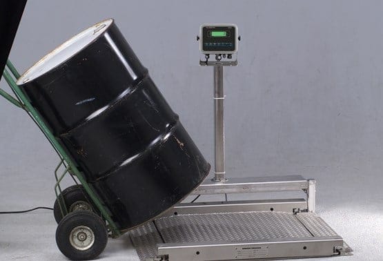 Drum filling scale platform in a chemical processing facility used for controlled filling, target weights, and overfill prevention