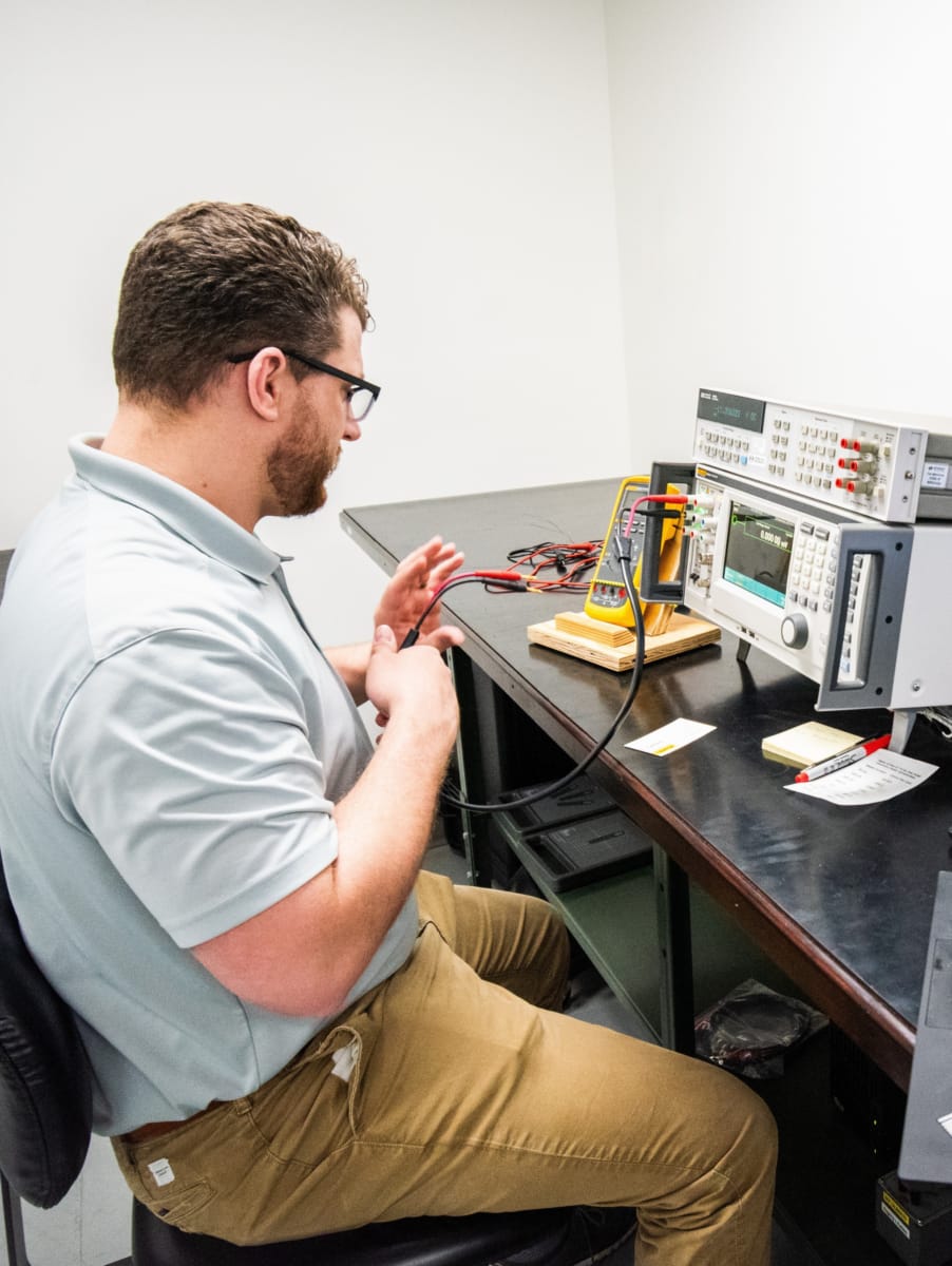 Technician working with electronic measurement equipment