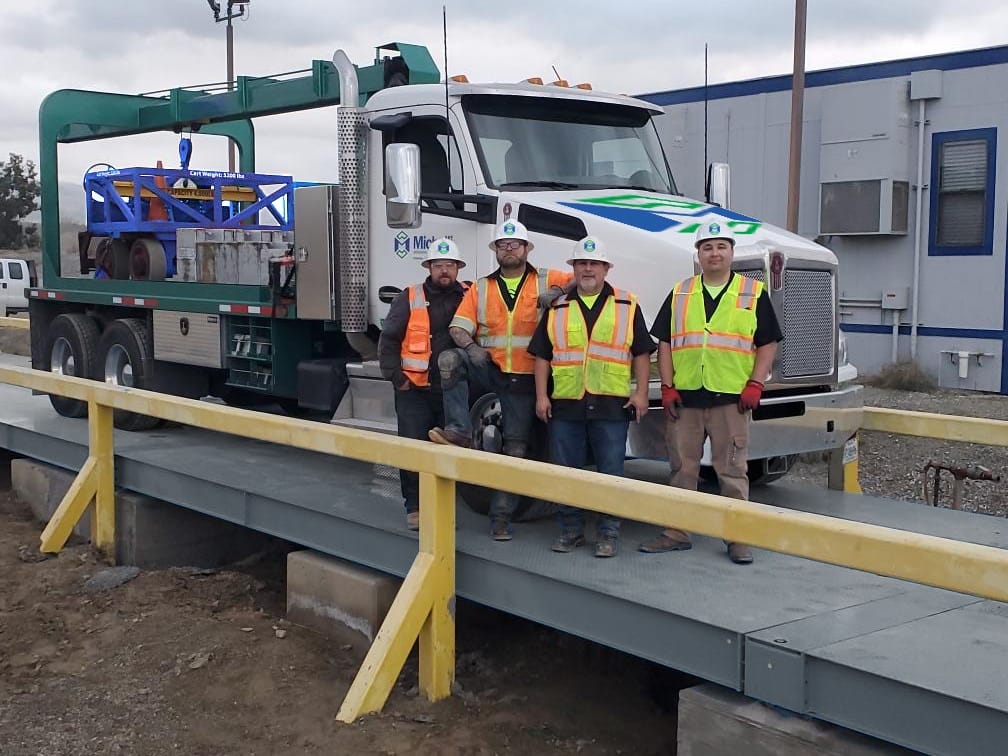 Michelli technicians working together around a large industrial scale