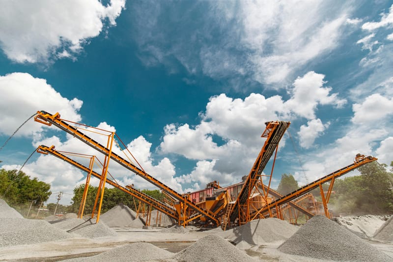 Large industrial conveyor belts transporting gravel for loadout and transactional support