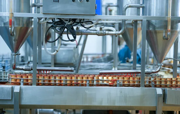 Canned goods on a conveyor belt in an industrial canning and line integration facility