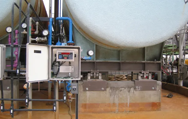 Industrial tank with control panel and piping for PLC, HMI, and SCADA integration projects