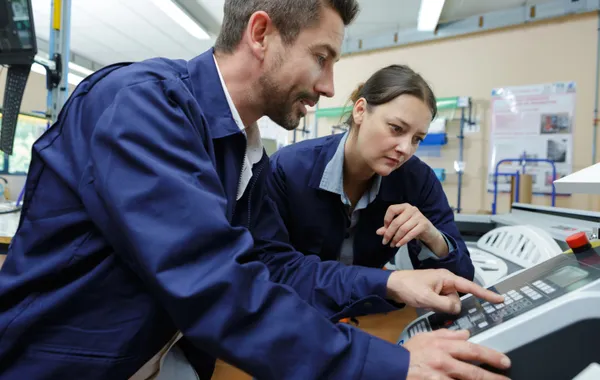 Technicians operating an industrial machine representing local Michelli partner equipment support