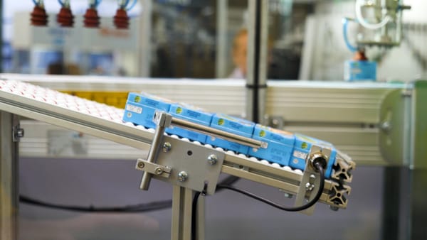 Cartons on an automated conveyor belt representing simple in-motion checkweighing applications