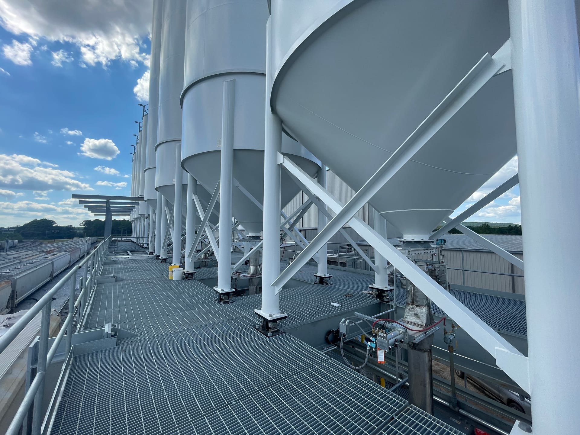 Industrial silos under a blue sky
