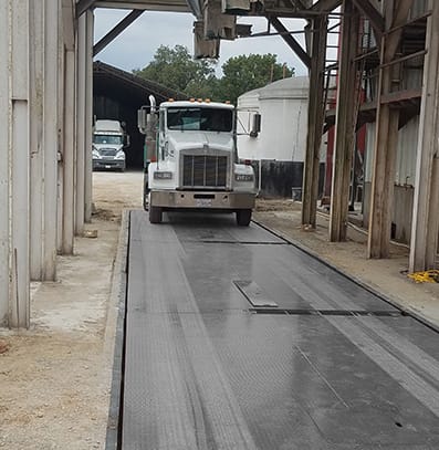 Truck on an industrial weighbridge at a manufacturing and distribution facility