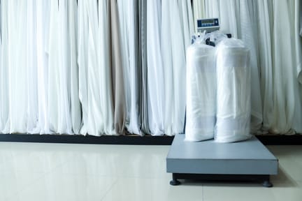Fabric rolls and weighing scale in an industrial counting and measurement setting