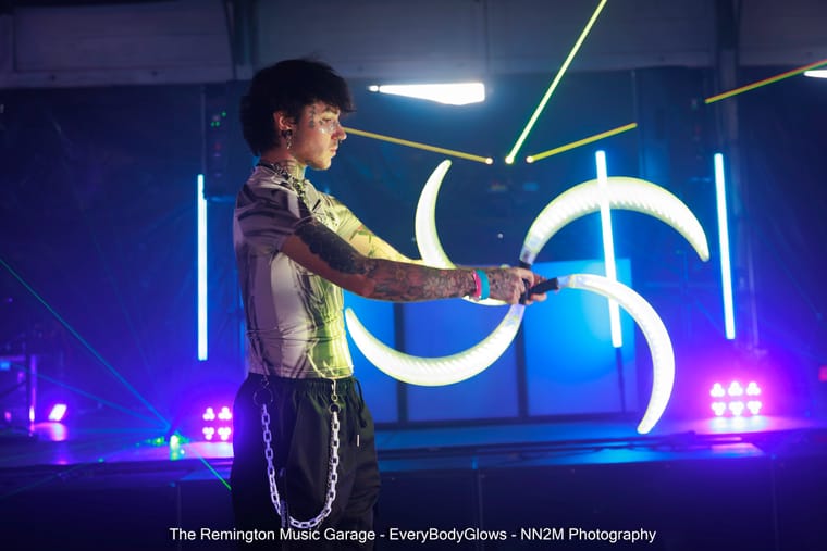 A performer with illuminated props at The Remington Music Garage