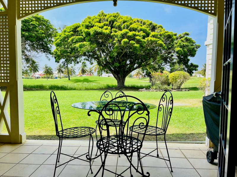 Scenic patio view with iron furniture, Tobago Plantations Apartment