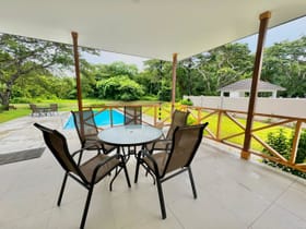 Villa 50 Samaan Grove covered porch overlooking infinity pool