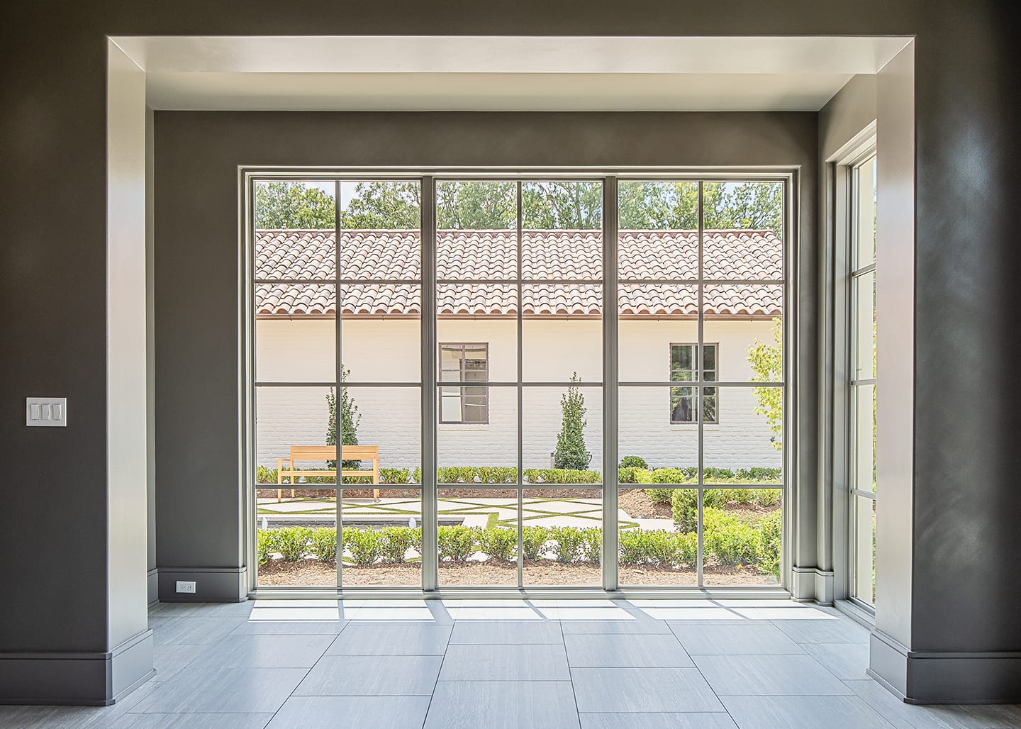 Dining with Marvin windows and limestone mantel