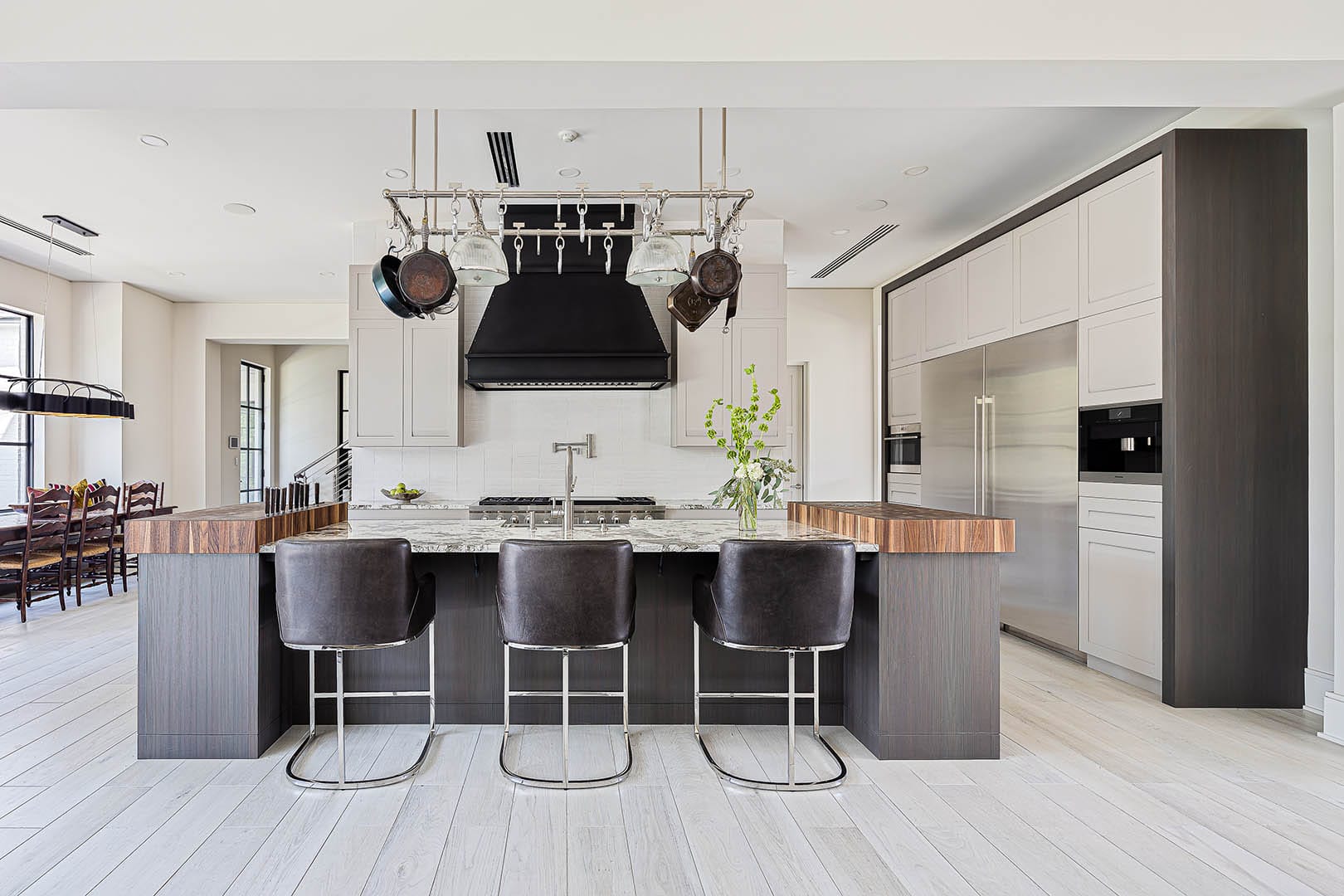 Gourmet kitchen with Grothouse wood island by The Cottage