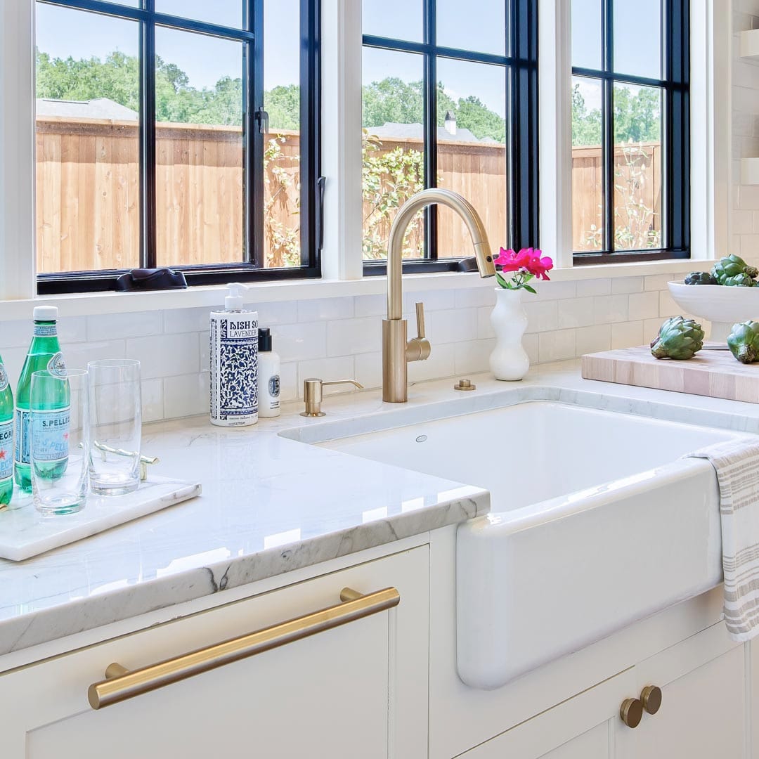 Luxury kitchen with custom hood and island by The Cottage