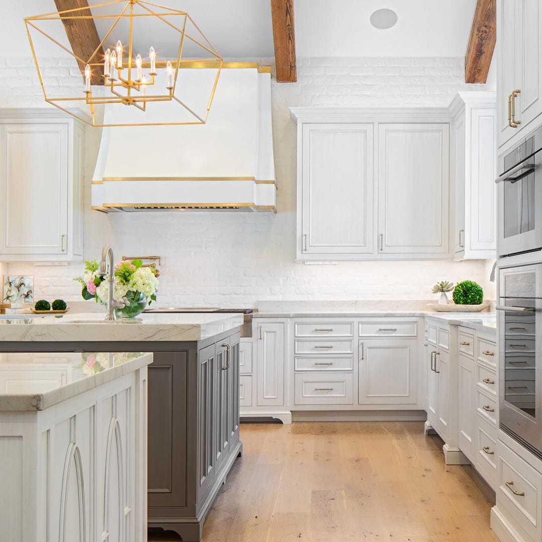 Luxury kitchen with custom island and upscale finishes by The Cottage