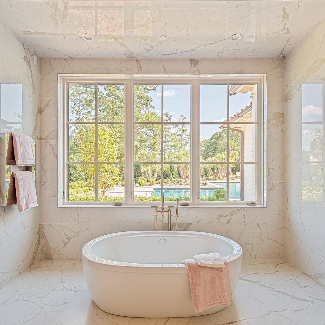 Luxurious master bath with custom tile work by The Cottage