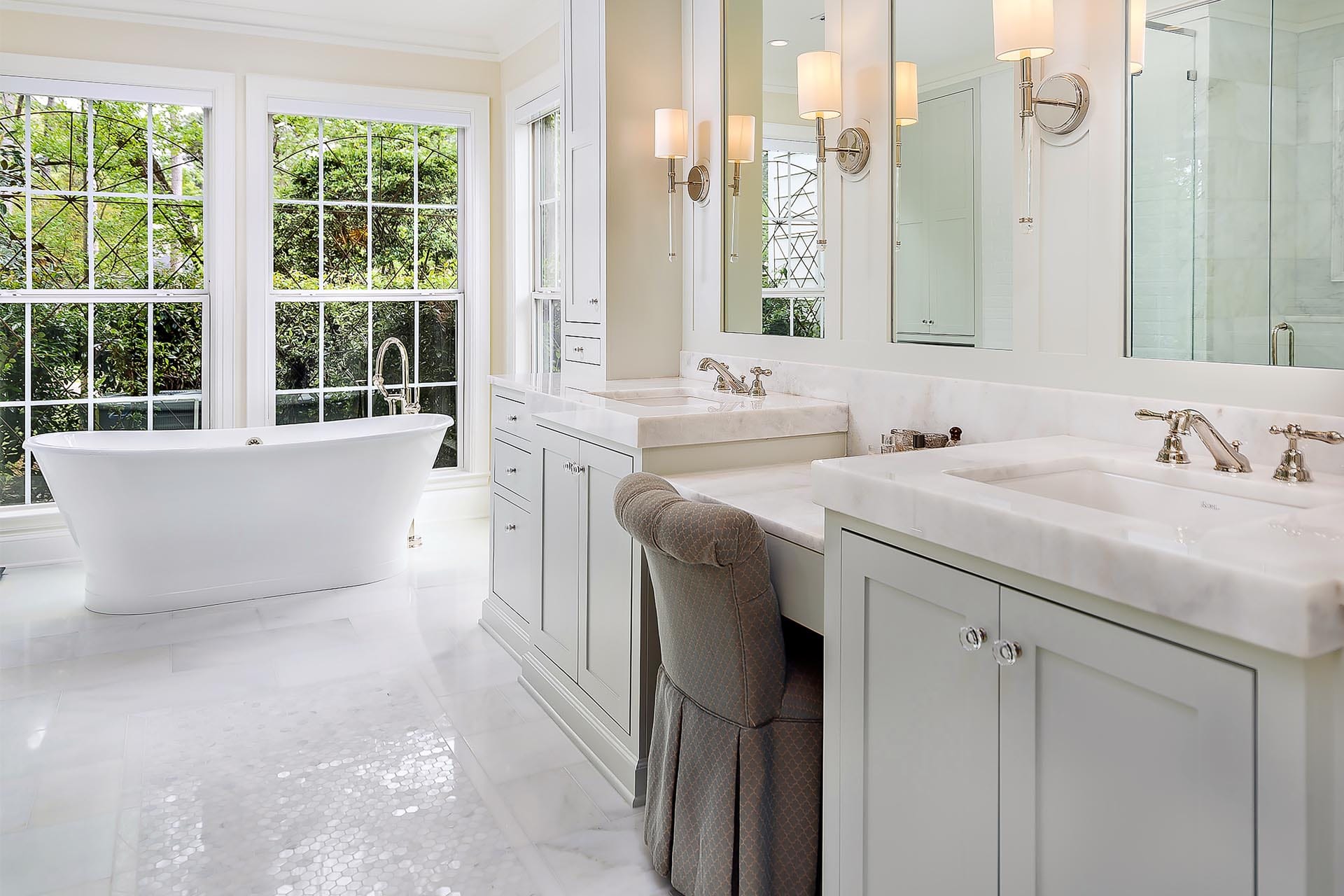 Elegant bathroom with freestanding tub by The Cottage