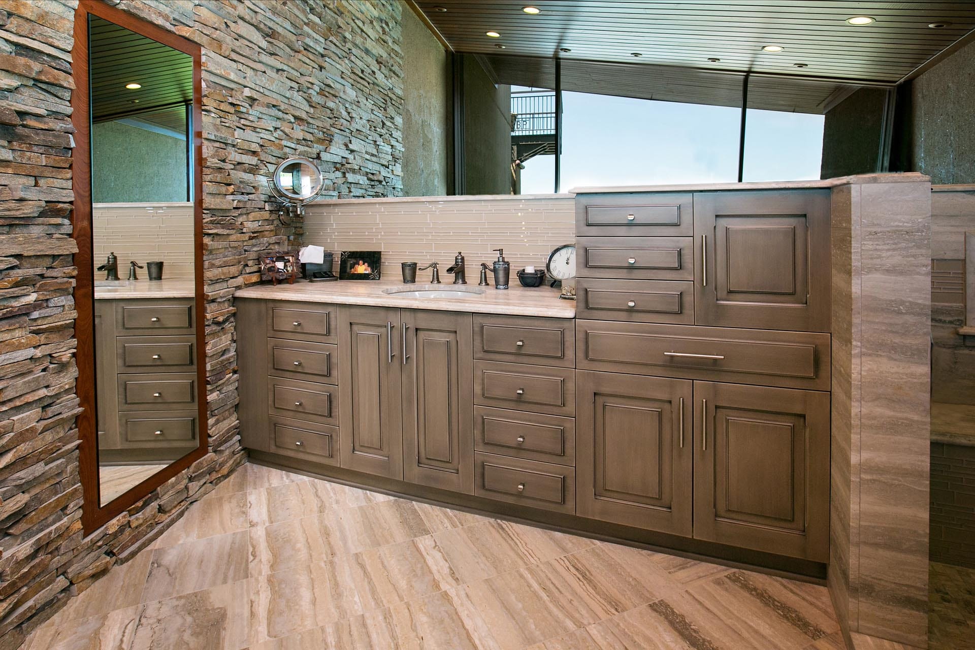 Spa bathroom with stone tile by The Cottage Shreveport