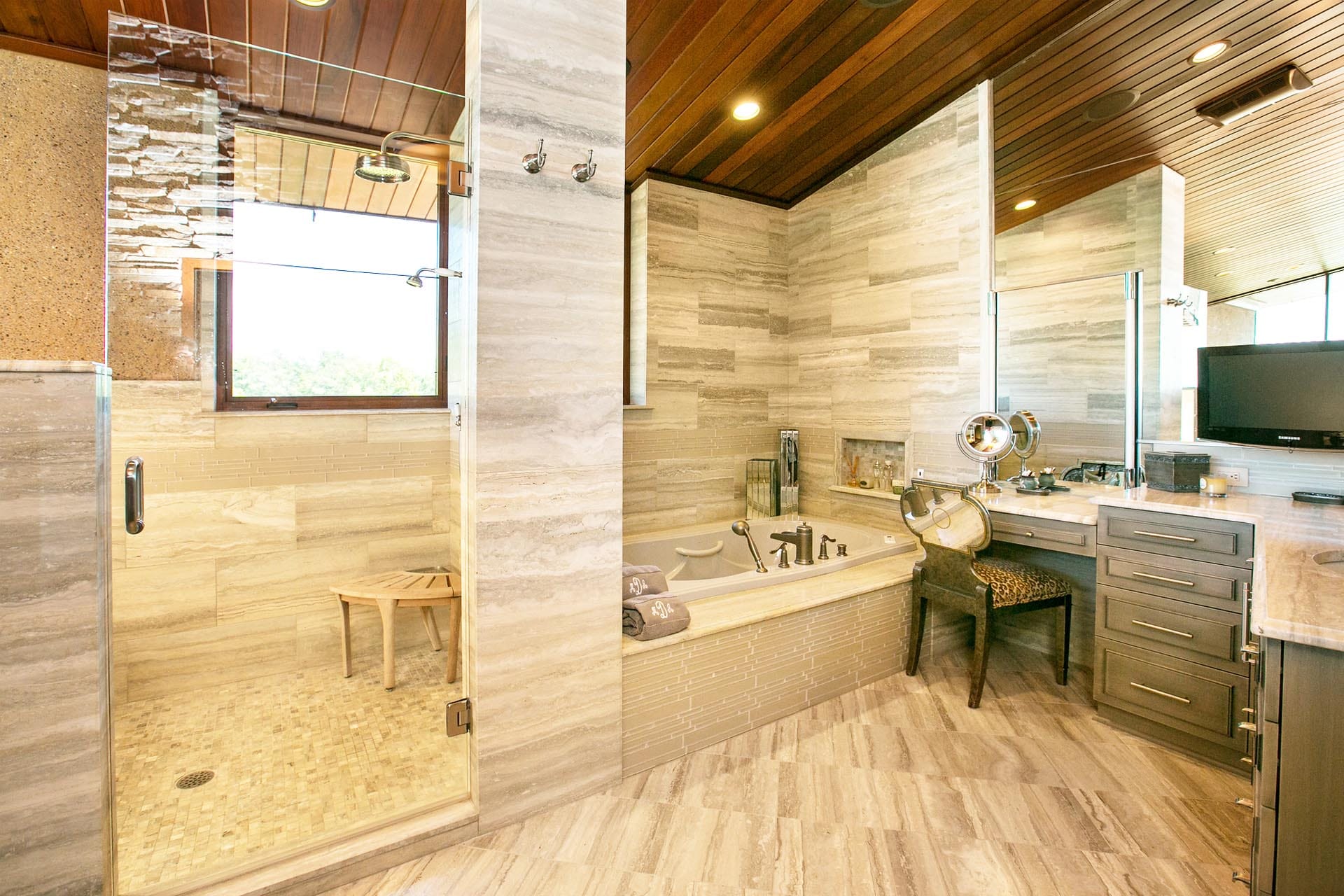 Designer bathroom with custom tile and cabinetry by The Cottage