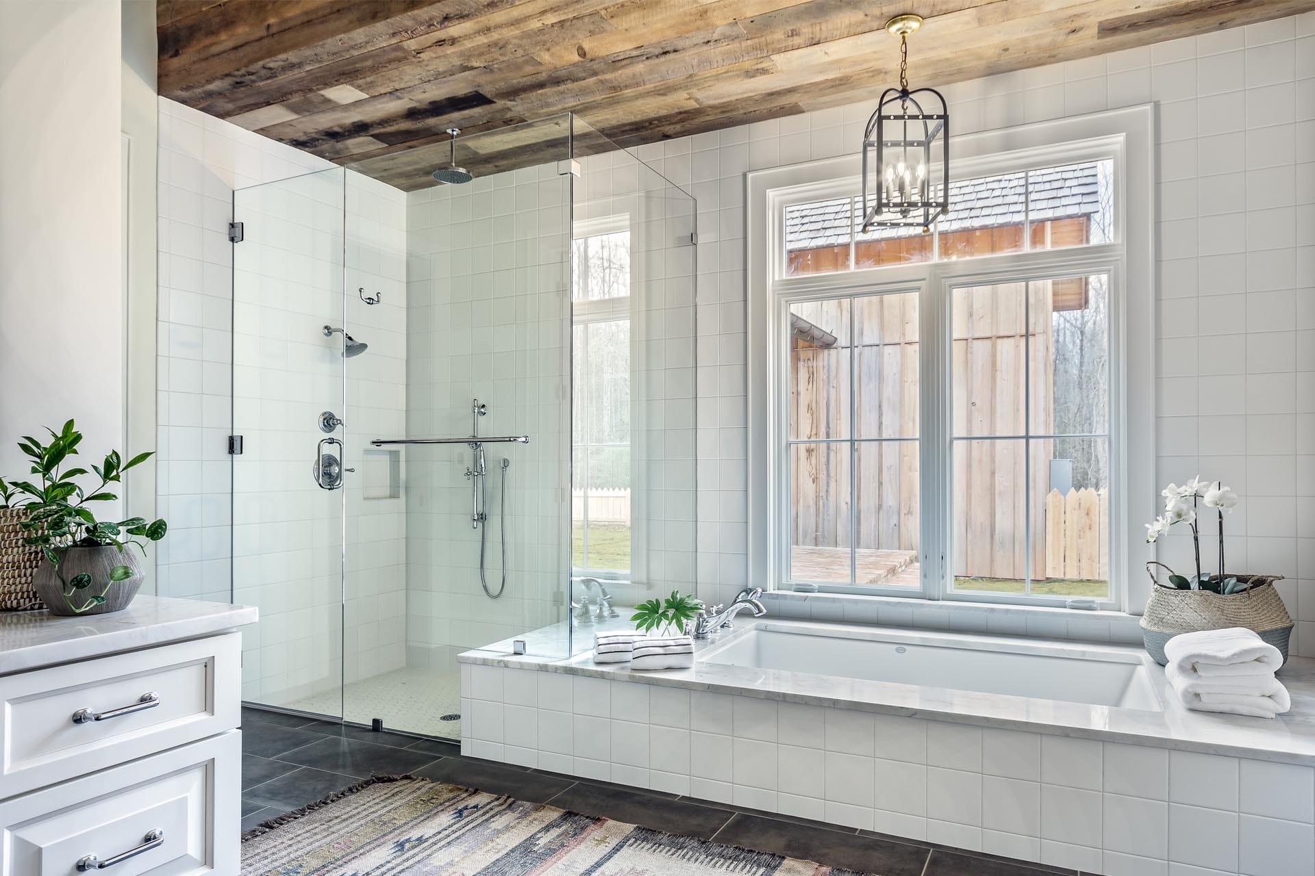 Luxurious bathroom with freestanding soaking tub by The Cottage