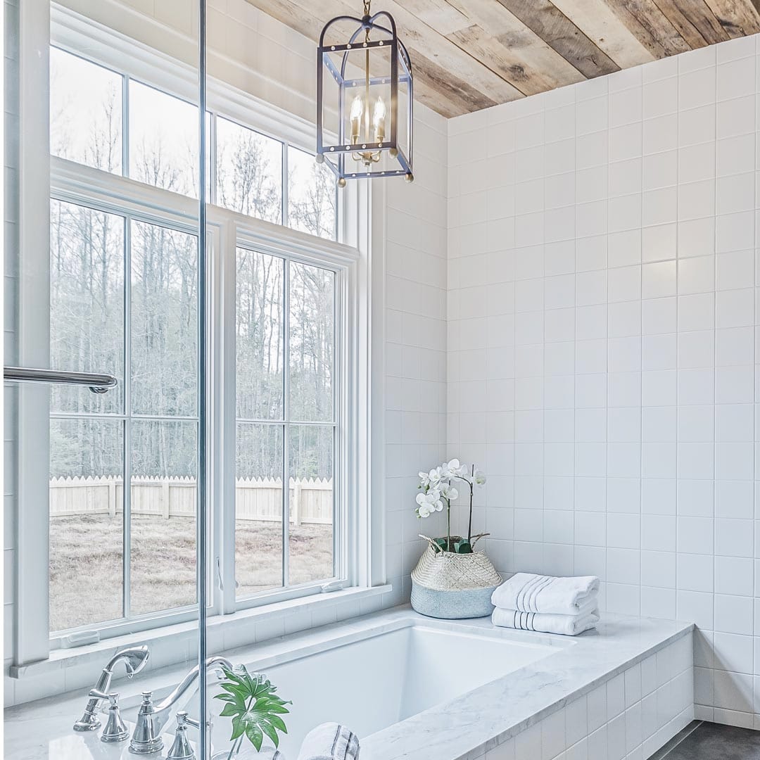 Master bathroom design with marble finishes by The Cottage