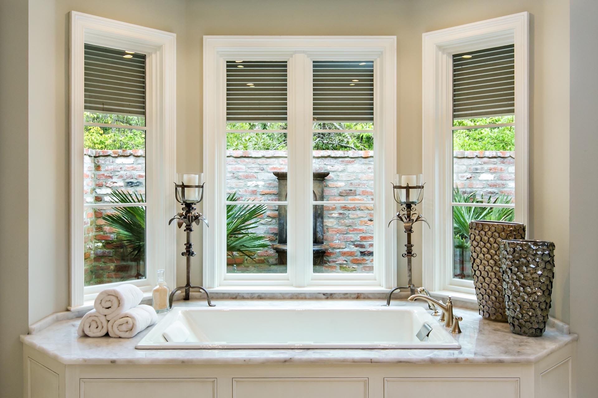 Custom bathroom with premium stone tile and fixtures by The Cottage