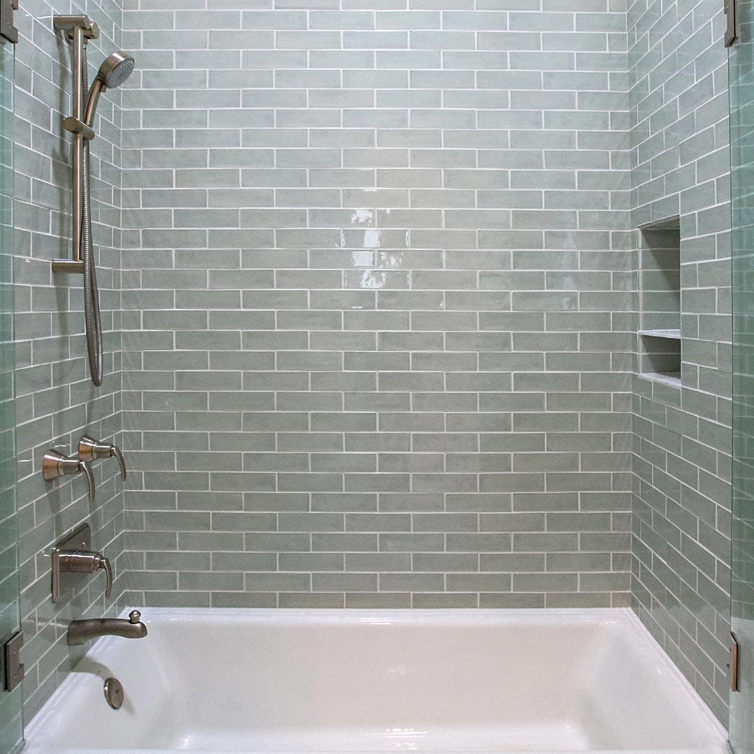Beautiful bathroom with custom vanity and stone tile by The Cottage