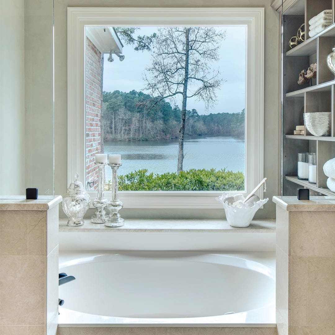Custom luxury bathroom with stone tile accents by The Cottage